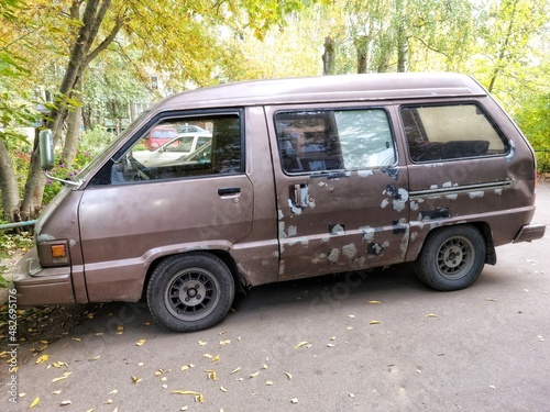 old battered car minivan. old abandoned car.