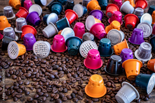 Coffee beans roasted, instant and grinded coffee in the mugs and coffee capsules on the wooden table photo