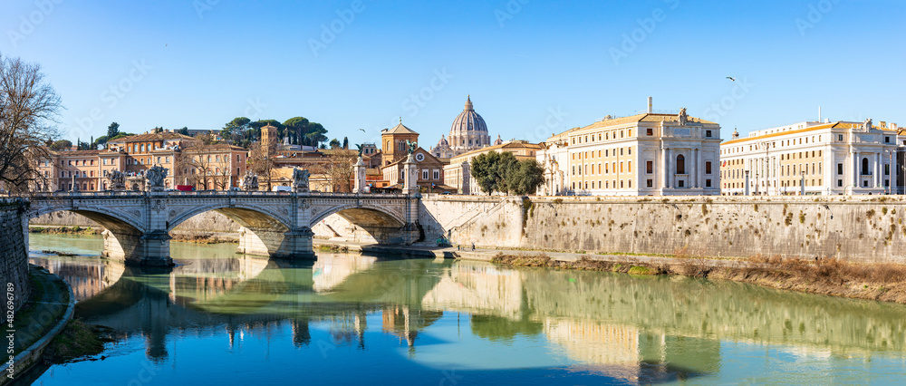 Blue sky over St. Peter's basilica and its reflection on Tiber river
