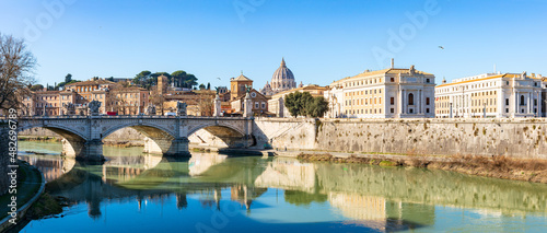 Blue sky over St. Peter's basilica and its reflection on Tiber river