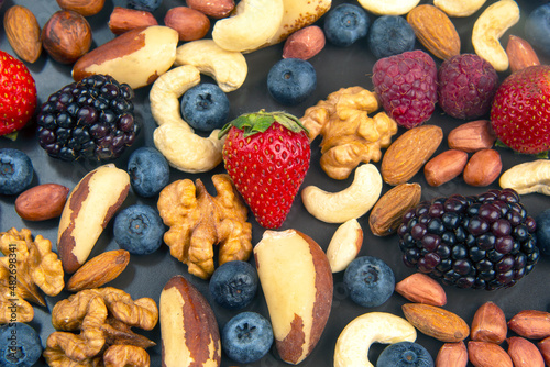 different berries and nuts on a plate. vitamin proteins and healthy foods