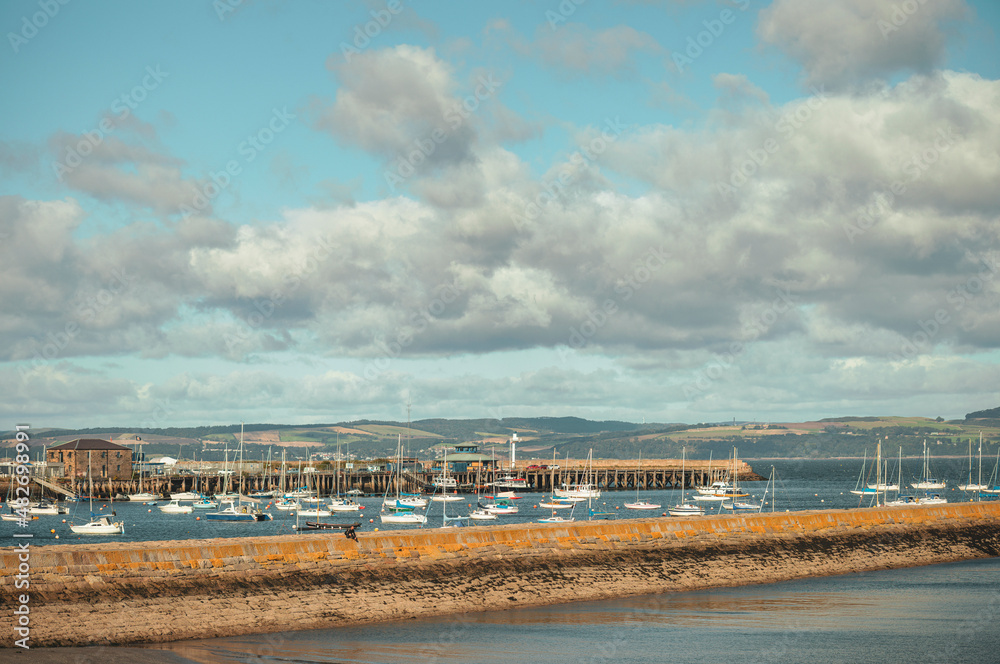 Iconic marina, located along the east coast of Scotland, presents a stunning view of the sea. Taking an aerial view of the marina, the image displays a stunning image of the marina yachts and boats. Iconic marina, located along the east coast of Scotland, presents a stunning view of the sea. Taking an aerial view of the marina, the image displays a stunning image of the marina yachts and boats.