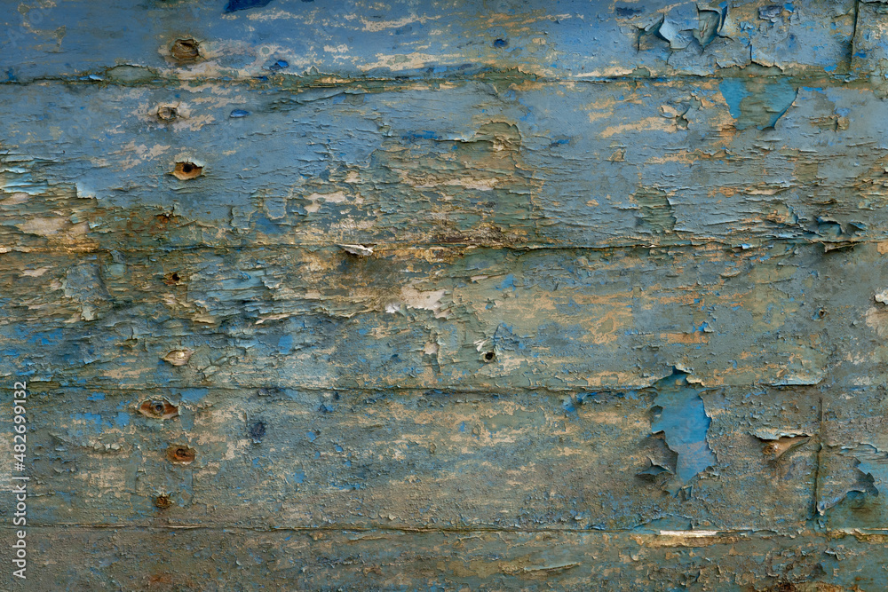 Worn painted wood textured backdrop from a decaying boat in the Scottish Highlands. Skye Boat peeling wood texture background Worn painted wood textured backdrop from a decaying boat in the Scottish Highlands. Skye Boat peeling wood texture background