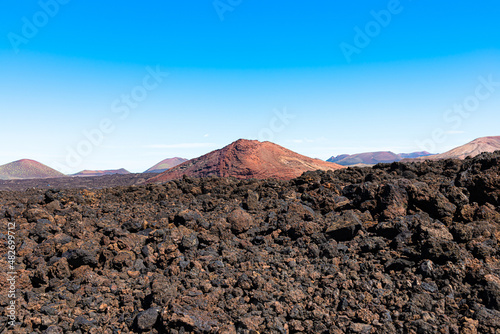 Melted Lava rocks magma flows from Timanfaya Volcanoes National Park at Lanzarote, Canary Islands, Spain