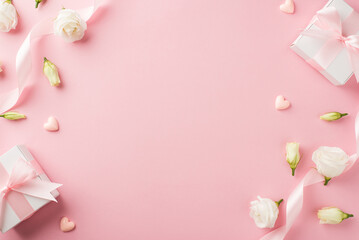 Top view photo of woman's day composition gift boxes with bows pink ribbon small hearts and prairie gentian flowers on isolated pastel pink background with copyspace