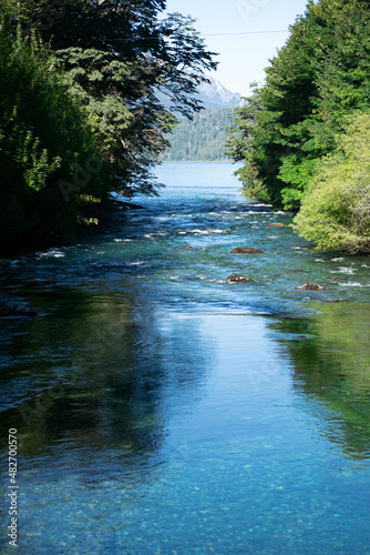 lago de agua color azul y celeste con arboles y montaña © Derlys