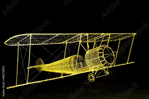 stylized model of a retro biplane aircraft illuminated with led lights at night