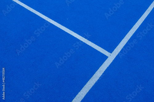Lines of a blue synthetic grass paddle tennis court