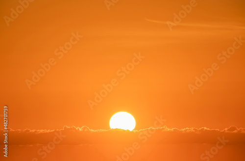 Sun rising in orange sky