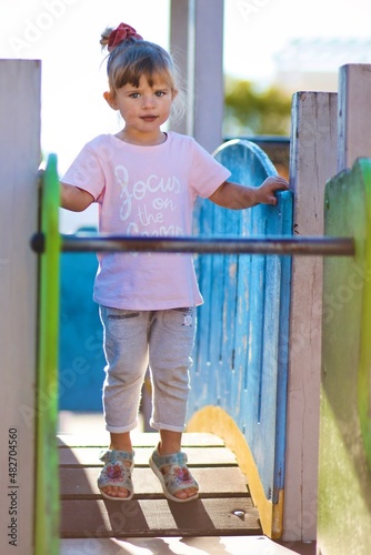 little child playing on the playground © Marius