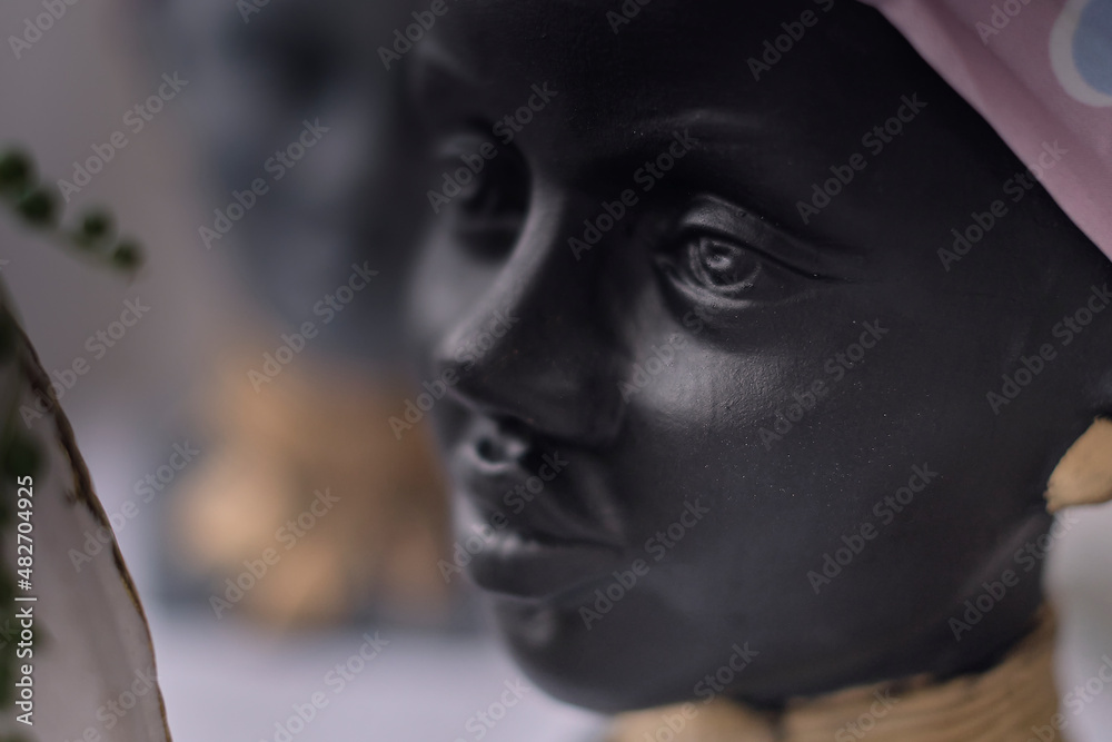 African American Woman bust. pots for flowers in the form of a woman's head. soft focus