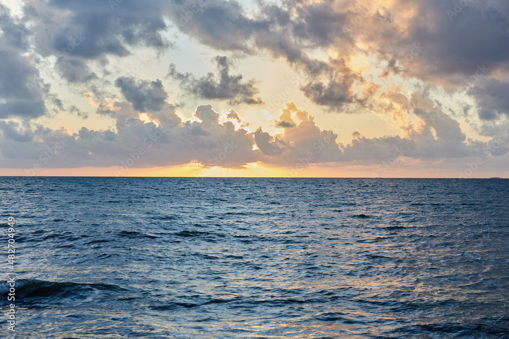 Clouds over ocean at sunrise Clouds over ocean at sunrise
