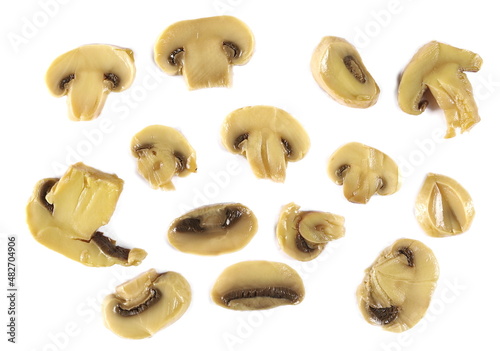 Champignon mushrooms slices pile isolated on white, top view 