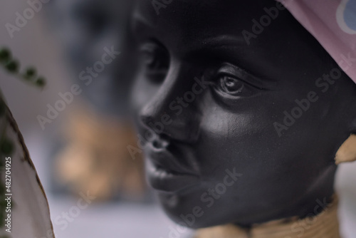 African American Woman bust. pots for flowers in the form of a woman's head. soft focus © yavdat