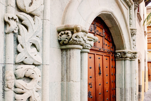 Facade of the Columbus house museum in Las Palmas de Gran Canaria, with its stone arch and beautiful wooden door.