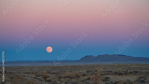 USA, New Mexico, Shiprock, Full moon rising over Navajo Nation desert landscape photo