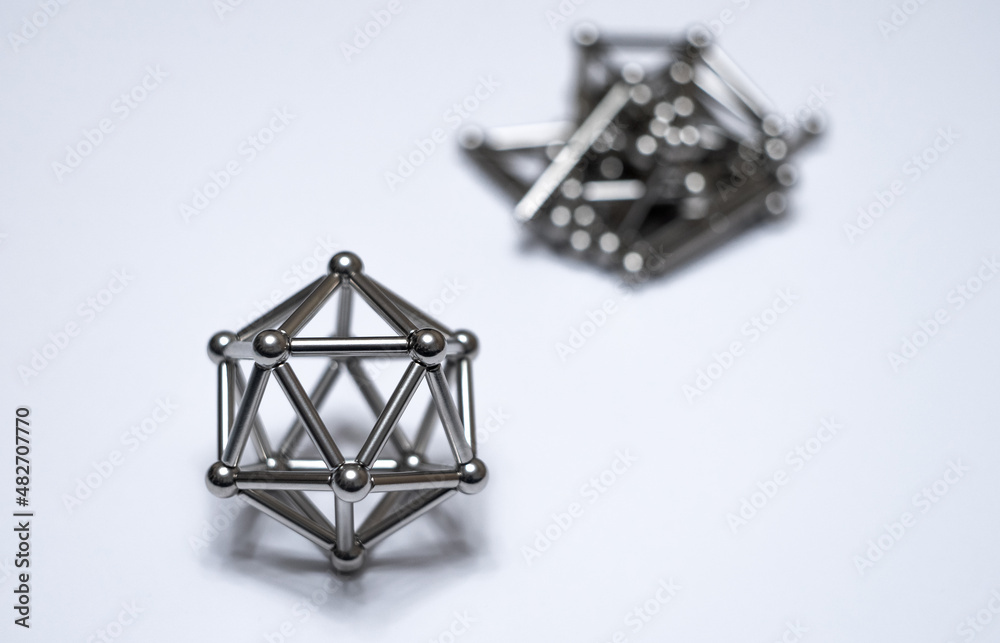 A figure from a magnetic constructor on a white isolate. Round magnetic balls. A toy for children made of metal. A figure from a magnetic constructor on a white isolate. Round magnetic balls. A toy for children made of metal.