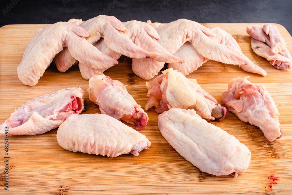 Cutting Up Raw Chicken Wings into Wingettes and Drumettes Cutting