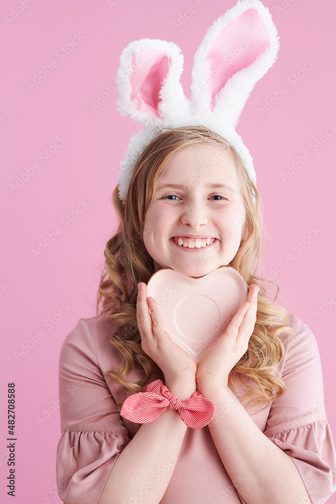 happy modern girl with long wavy blond hair on pink