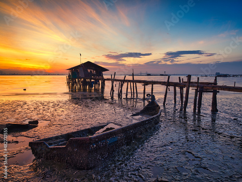 sunset on broken fishing boat