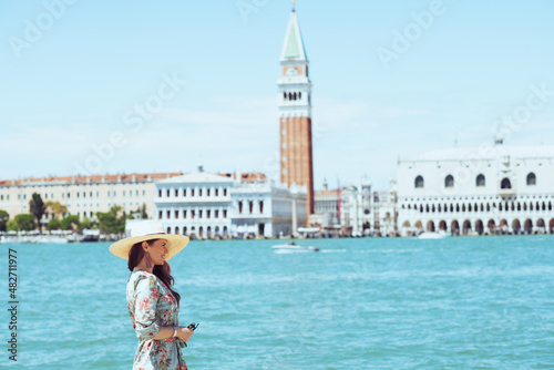 Fotografie, Obraz relaxed young woman in floral dress having walking tour
