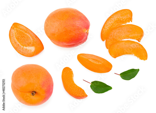 apricot fruits with slices and green leaf isolated on white background. clipping path. top view