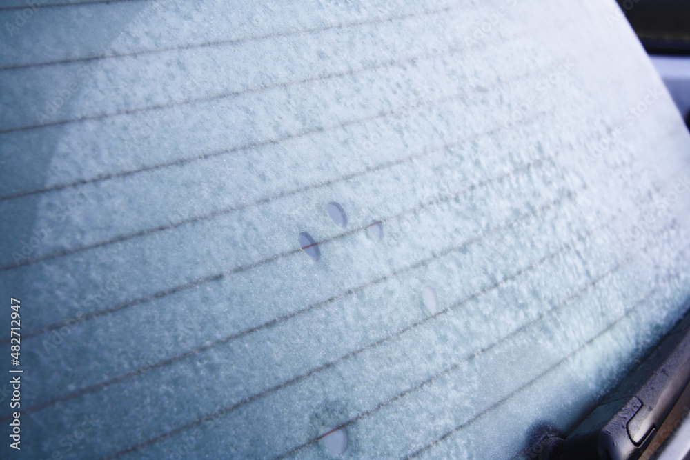 Fototapeta premium Frozen Back window of car. Ice crystals on glass. Rear view. 