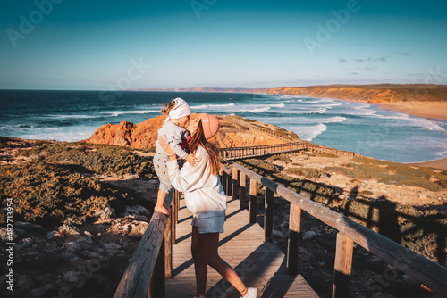 mother kissed her daughter at the beach in portugal algarve