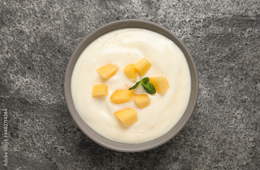 Delicious yogurt with fresh peach and mint on grey table, top view Delicious yogurt with fresh peach and mint on grey table, top view