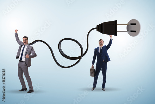 Businessman being powered by electric power