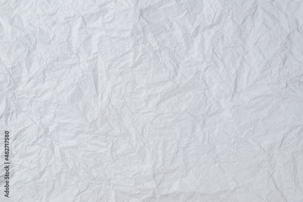 Crumpled white paper background.