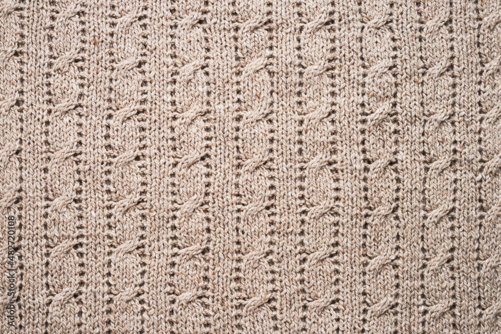 Beige handmade knitwork, wool knitwork for artisan backdrop or background. Beige knitted background Beige handmade knitwork, wool knitwork for artisan backdrop or background. Beige knitted background