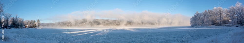 Panoramic view of a winter scene with a lake and ice steam view of a winter scene with a lake and ice steam