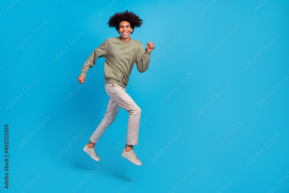 Full length profile side photo of young guy run rush motion energetic discount isolated over blue color background