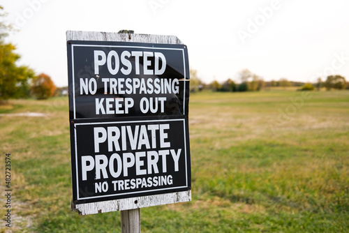 No Trespassing Keep Out Sign near a Large Field