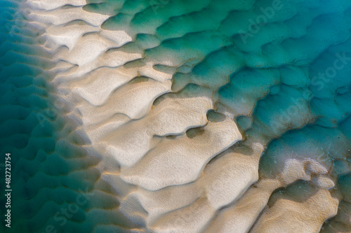 Aerial view of a river with sand bar exposed at low tide, Oregon coast, USA.