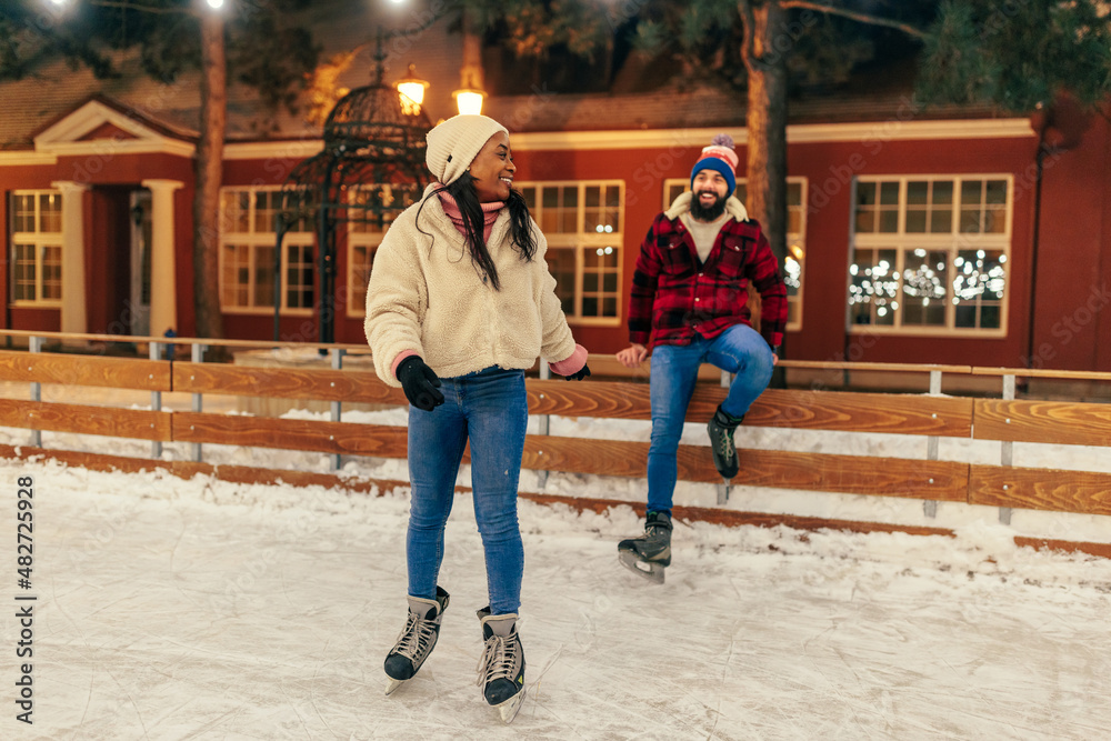 Lovely couple on ice skating outdoors