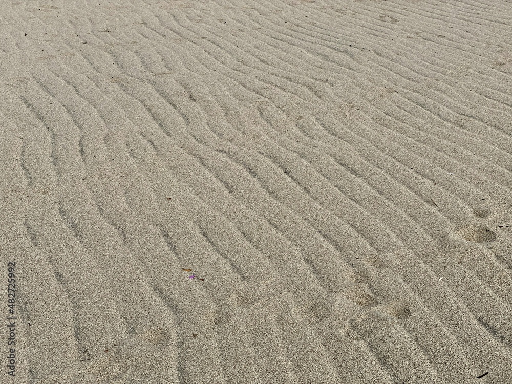 Wave ripples on sand creating abstract beach background Wave ripples on sand creating abstract beach background