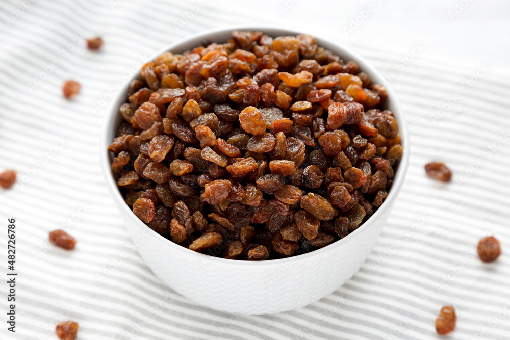 Dried Brown Raisins in a Gray Bowl, side view. Dried Brown Raisins in a Gray Bowl, side view.