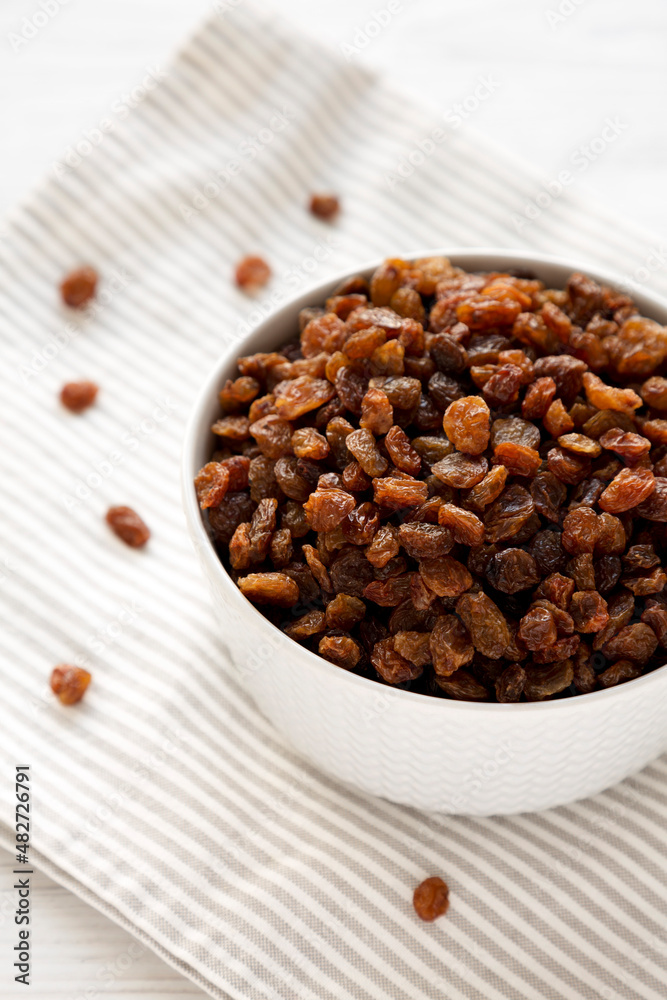 Dried Brown Raisins in a Gray Bowl, side view. Dried Brown Raisins in a Gray Bowl, side view.