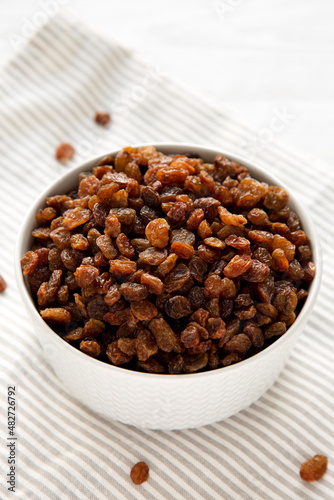 Dried Brown Raisins in a Gray Bowl, side view.