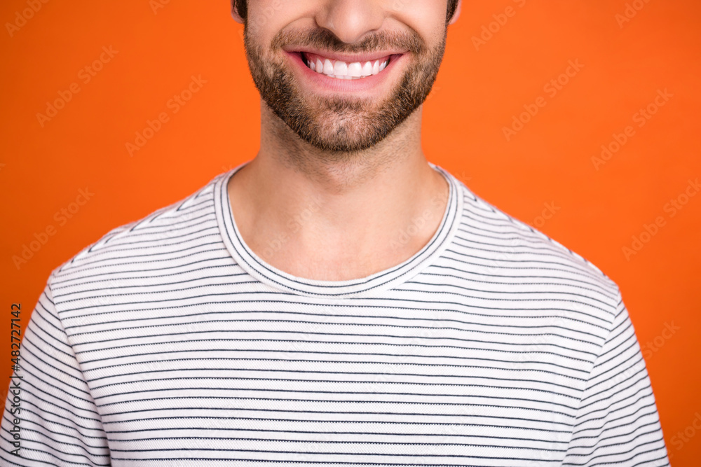 Cropped photo of young cheerful guy restoration stomatology dentist isolated over orange color background Cropped photo of young cheerful guy restoration stomatology dentist isolated over orange color background