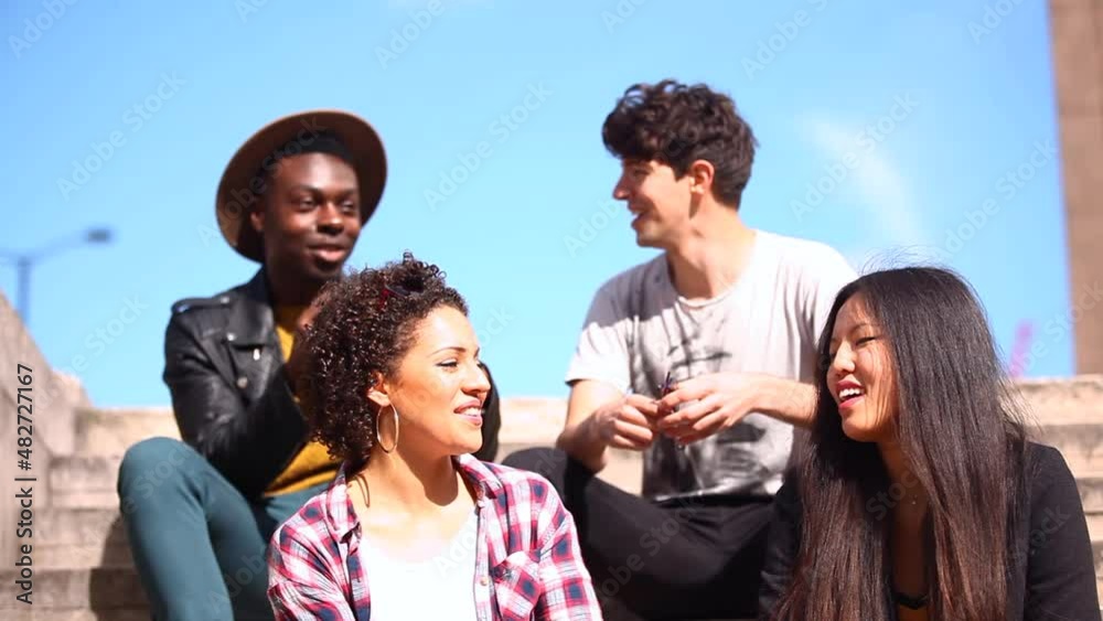 Multiracial group of friends meeting in London, talking and having fun together Multiracial group of friends meeting in London, talking and having fun together