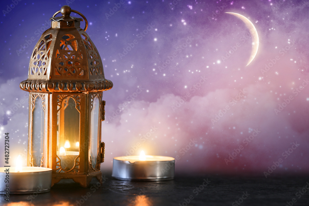 Muslim lamp and candles on table at night. Ramadan celebration Muslim lamp and candles on table at night. Ramadan celebration