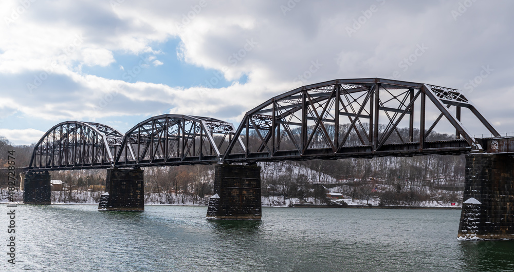 A metal train bridge over the Allegheny River in Aspinwall, Pennsylvania, USA on an overcast winter day