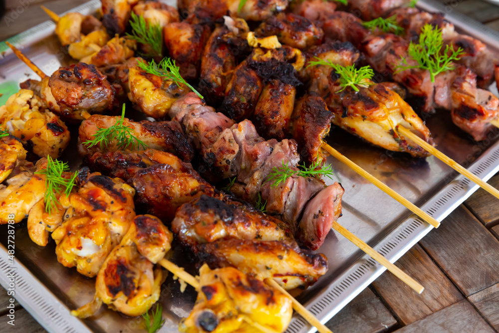Top view of tasty shish kebab from pork and chicken on a tray. High quality photo