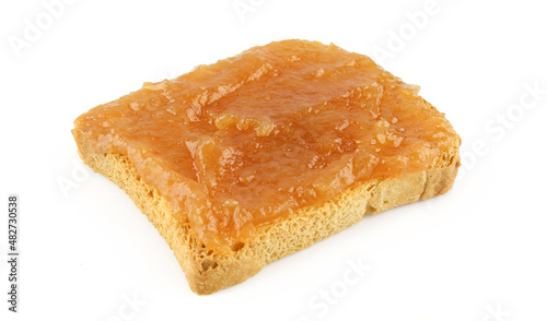 Homemade apricot jam on a toast isolated on white background