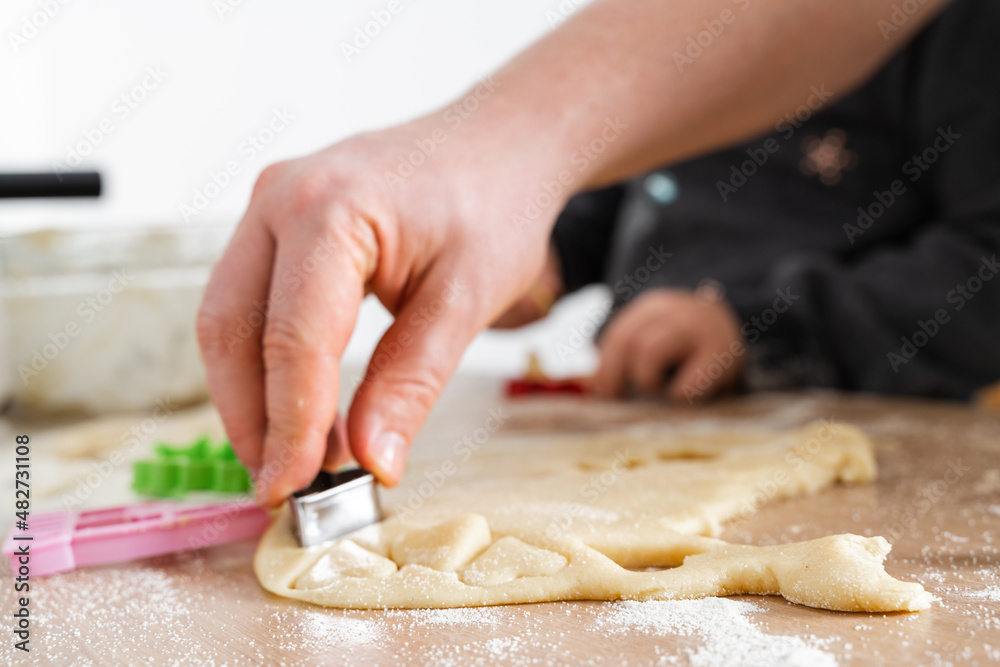 Father feeling playful with his caucasian little daughter, while preparing homemade dough for tasty cookies. Father and his child spending time at home 
