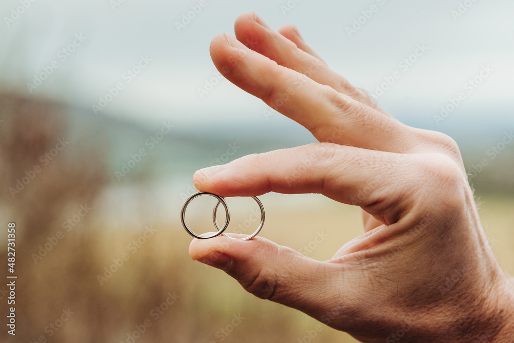 Two wedding rings in the groom's hand Two wedding rings in the groom's hand