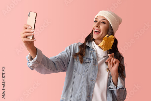Young smiling woman taking ...